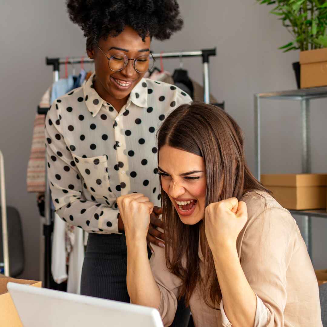women smiling at computer